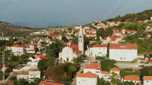 Catholic Church of Our Lady of Mount Carmel In Nerezisca Village, Brac Island In Croatia. - aerial shot photo