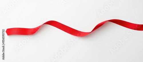Curved red ribbon line extending horizontally on a white background with ample empty space for text or design elements. photo