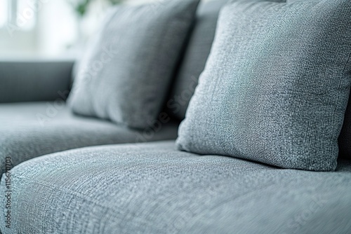 Soft blue sofa with textured fabric and cozy pillows invites rel photo