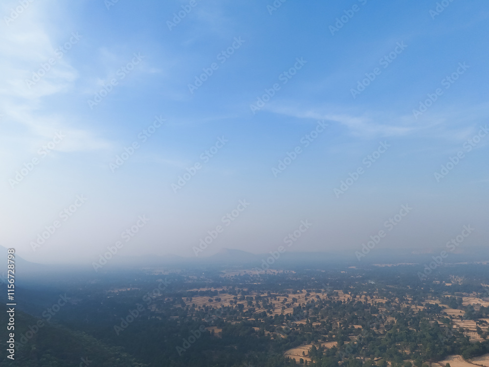 Mountain valley under clear blue sky, Scenic aerial view of green hills, Natural landscape with rocky mountains, Rural fields and forest panorama, Tranquil mountain region, Lush greenery Stock Photo. Mountain valley under clear blue sky, Scenic aerial view of green hills, Natural landscape with rocky mountains, Rural fields and forest panorama, Tranquil mountain region, Lush greenery Stock Photo.