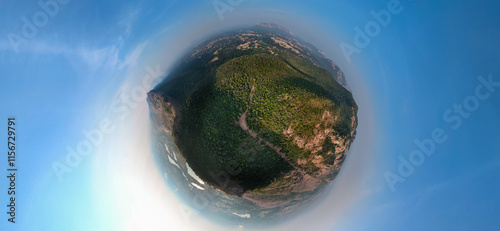 tiny planet aerial view, spherical forest landscape, drone panoramic photography, lush green mountain view, unique 360-degree nature perspective, circular earth view stock photo. photo