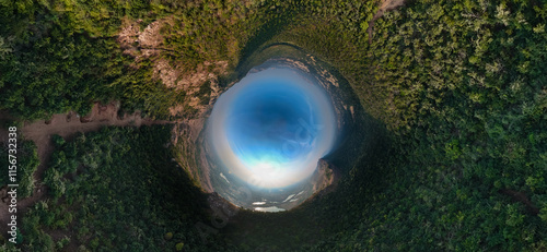 drone spherical view of forest, 360-degree forest panorama, tiny planet view nature, aerial wraparound forest shot, immersive drone photography, lush green wilderness, unique nature perspective. photo