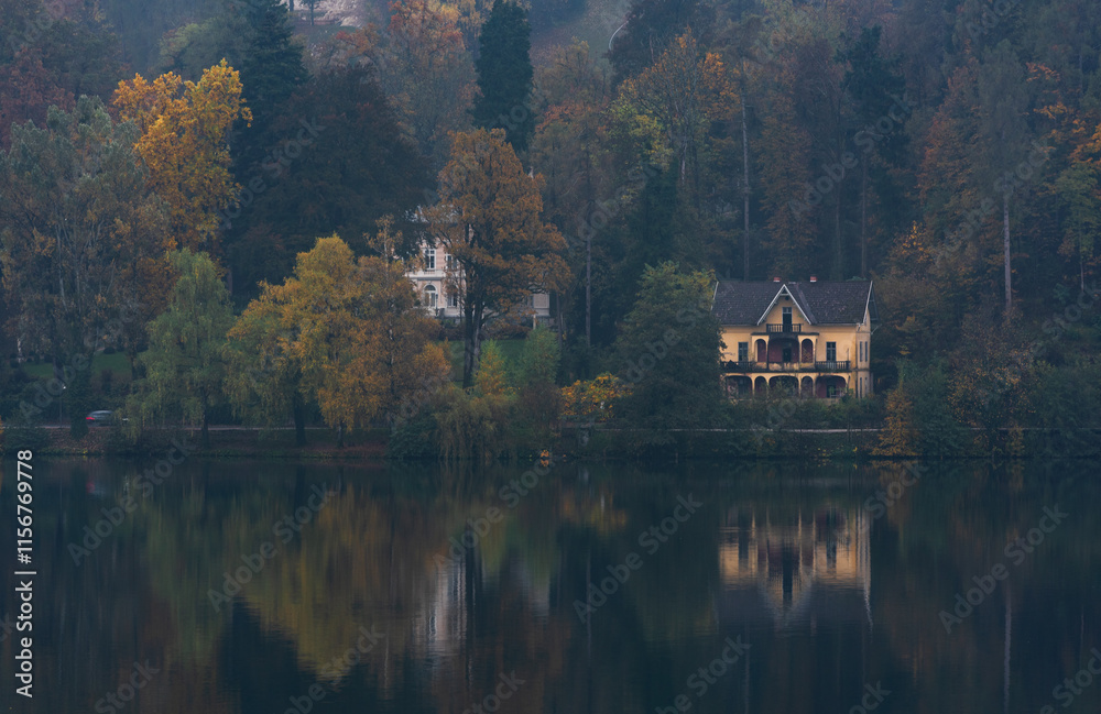 Fototapeta premium Fog rolling over the lake and forest in autumn. Lake Bled Slovenia