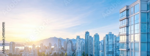 Urban landscape of a vibrant city at sunrise featuring glass skyscrapers with stunning reflections and a backdrop of mountains and a tranquil waterfront.