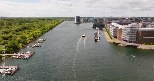 Aerial view following a harbour bus on Sydhavn river, summer in Copenhagen photo