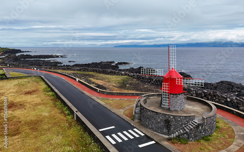 Traditional  red windmill at the coast of Pico island, Azores, Portugal photo