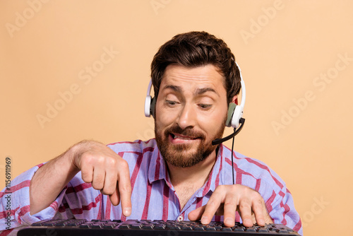 Portrait photo of brunet hair overworking adult man wearing headset click computer keyboard isolated on beige color background photo