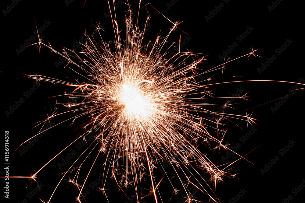 New Year's Eve celebration, sparkler spark in the darkness New Year's Eve celebration, sparkler spark in the darkness