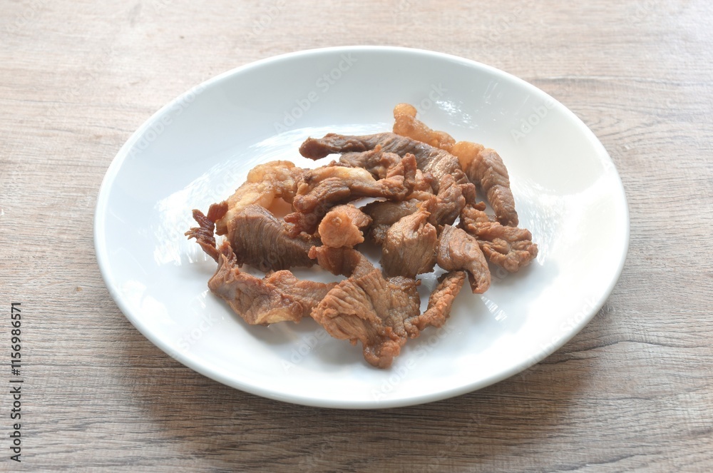 fried crispy salty fermenting beef meat with pandan and herb on plate fried crispy salty fermenting beef meat with pandan and herb on plate