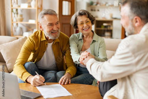 Quadro su tela Happy senior couple of clients meeting with real estate agent, shaking hands wit