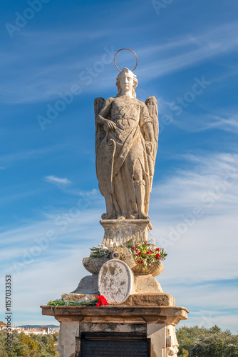 Cordoba, Spain - 28 October, 2024: San Rafael Statue at Roman bridge of Cordoba with blue sky - Cordoba photo