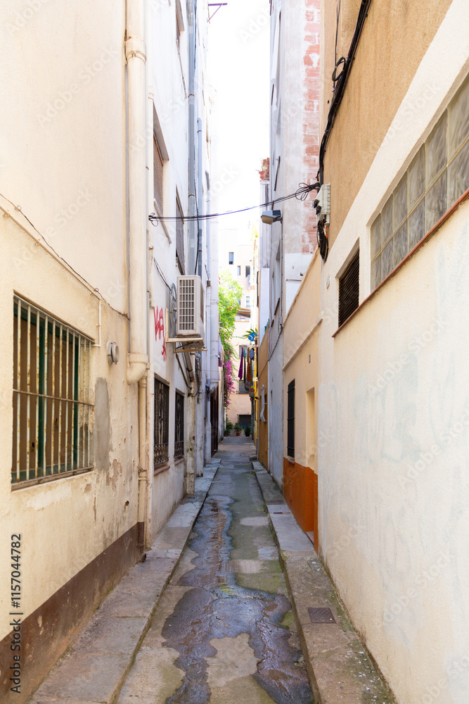 Narrow street leading to archway in spanish town
