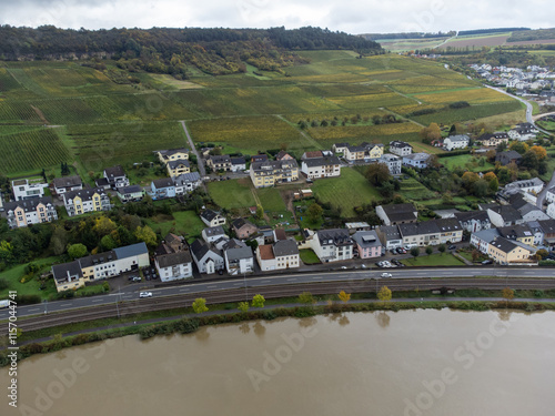 Aerial view of terraced vineyards around Nittel, Rhineland-Palatinate, Germany and views across Moselle River on vineyard hills of Machtum, Luxembourg photo