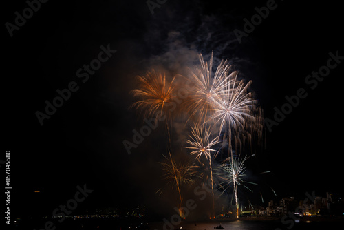Obraz na płótnie Colorful fireworks exploding over boats at night w salonie