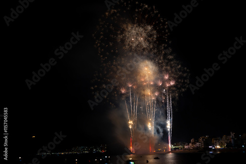 Obraz na płótnie Colorful fireworks exploding over boats at night w salonie