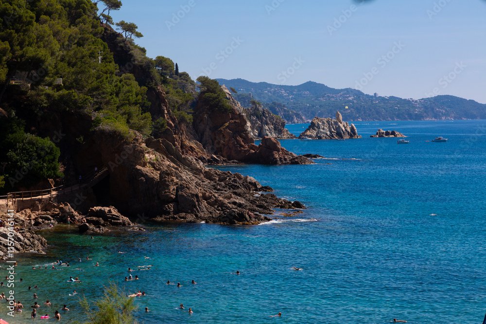 Beautiful turquoise mediterranean sea washing rocky coastline on sunny summer day