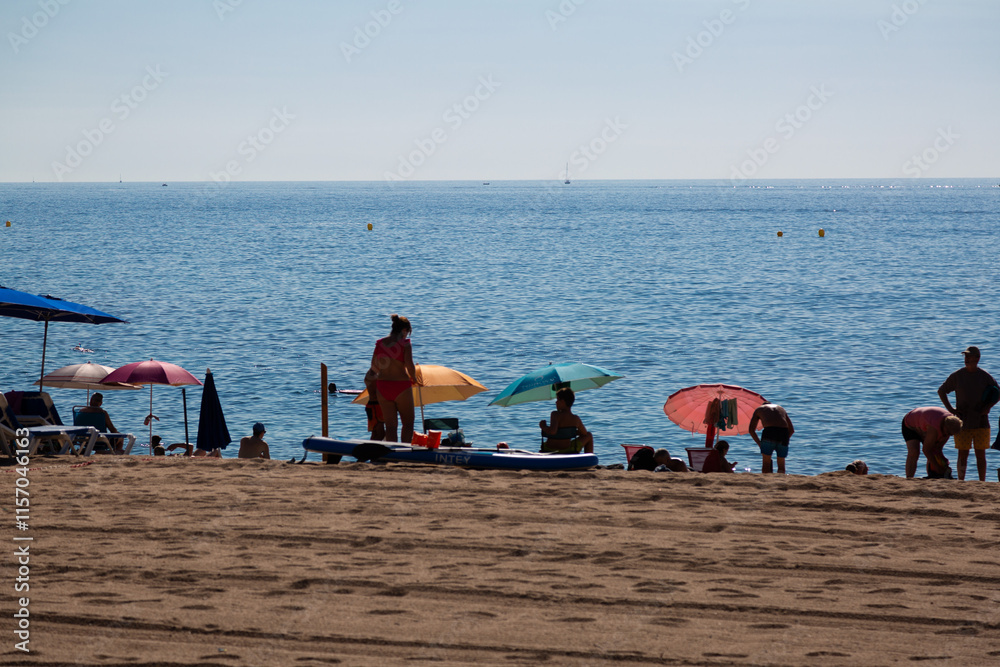 Tourists relaxing on the picturesque beach of aiguablava, costa brava, spain