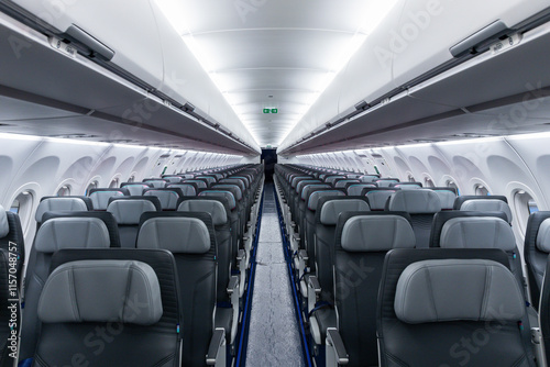 Economy class airplane cabin view with empty seat rows photo