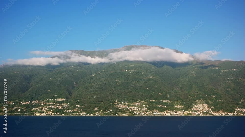 Video of low lying clouds over the mountains on Lake Como with the town of Bellera. The lake's water is at the bottom of the frame and the clouds at the top of the hills casting shadows. Video of low lying clouds over the mountains on Lake Como with the town of Bellera. The lake's water is at the bottom of the frame and the clouds at the top of the hills casting shadows.