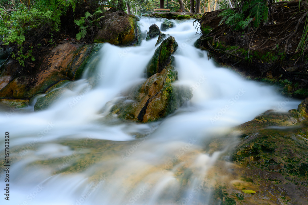 Fototapeta premium Soa Hot Spring Waterfall in Mangeruda, Flores, Indonesia with Thermal Water Flowing over Rocks