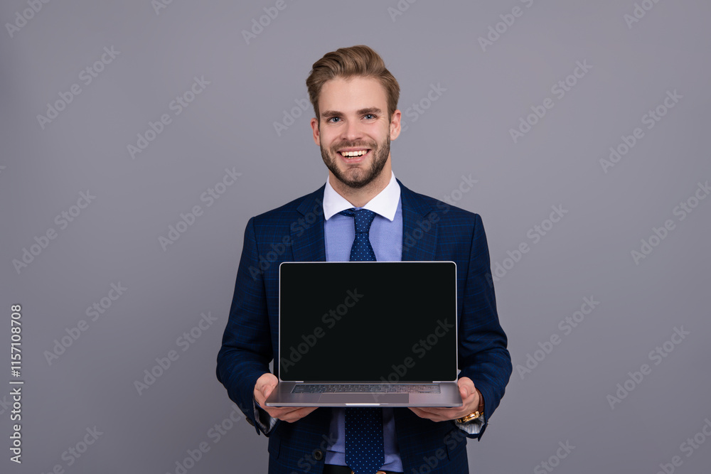 Product proposal. Advertisement presentation, copy space. Businessman presenting laptop app. Businessman show video on laptop isolated on grey. New business app. Online banking service. Good offer Product proposal. Advertisement presentation, copy space. Businessman presenting laptop app. Businessman show video on laptop isolated on grey. New business app. Online banking service. Good offer