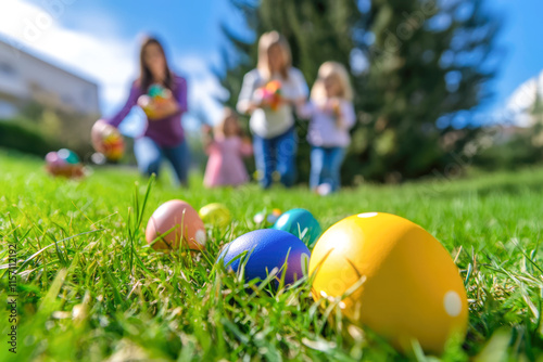 Family easter egg hunt in sunny park with kids and colorful eggs