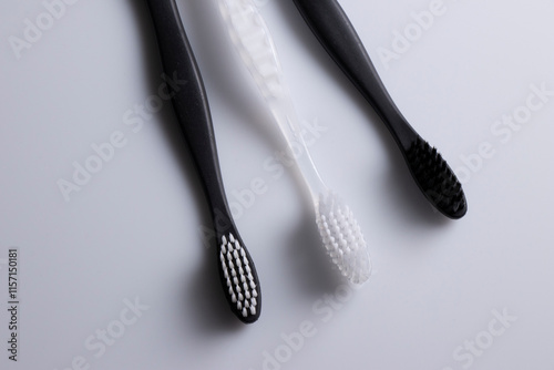 All black, white and combination of both toothbrushes isolated laid flat on a white background.