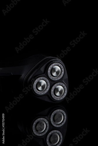 Closeup Image of 3 Blades Electric Shaver On Black Reflective Surface. Vertical image Composition