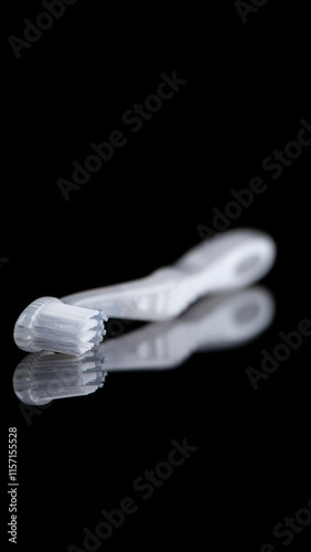 White-translucent toothbrush shot on a pure black background.
