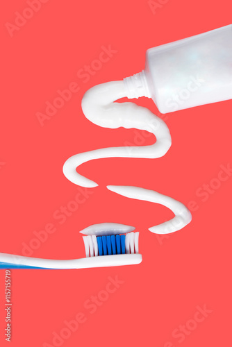 Toothpaste spread in a wave pattern floating in air. Isolated on a light red background. Floating