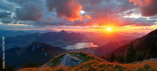 Colorful sunset view from Bavarian Herzogstand peak. Dramatic cloudscape over mountain range with lake. Scenic alpine landscape with vibrant sunset hues. High elevation perspective. Natural beauty. photo