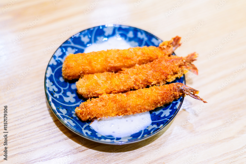 Golden Crispy Breaded Shrimp on Traditional Blue and White Porcelain Plate Golden Crispy Breaded Shrimp on Traditional Blue and White Porcelain Plate