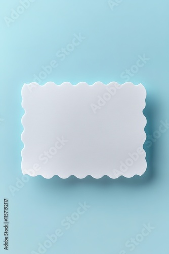 Clean, scalloped-edge card placed on soft blue background, exudi photo