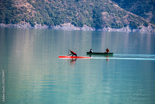 In calm waters, kayaking and boating activities are enjoyed by participants who are either rowing or waiting. The serene setting enhances the experience at Tehri Lake. photo