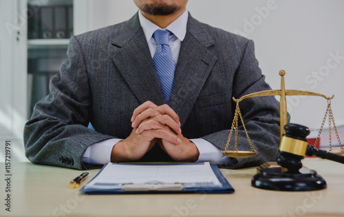 A dark-skinned Asian lawyer, dressed in professional attireon. provide legal advice, preparing cases in law office.