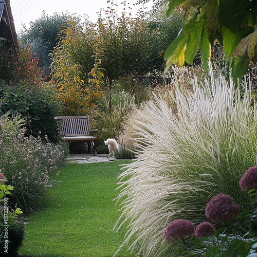 serene garden scene featuring lush green grass, ornamental grasses, and colorful flowers. white cat strolls along path, creating peaceful atmosphere