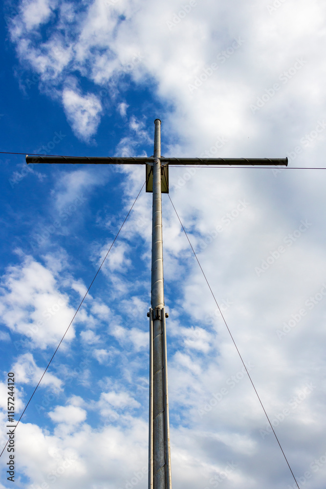 Metal Christian cross near the village of Krum, Municipality of Dimitrovgrad, Haskovo Province, southern Bulgaria, low-angle partial view on a cloudy background Metal Christian cross near the village of Krum, Municipality of Dimitrovgrad, Haskovo Province, southern Bulgaria, low-angle partial view on a cloudy background