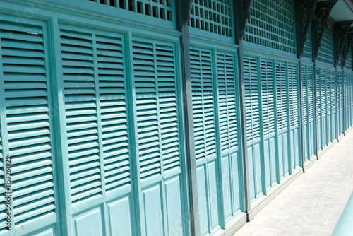 Light green antique wooden folding door wall at the ancient building.