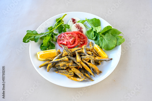 Fried Anchovies (Turkish Name: Hamsi Tava) .Hamsi, istavrit, sardalya tava. Balik kizartma. Izgara cipura levrek, palamut  yesil salata. photo