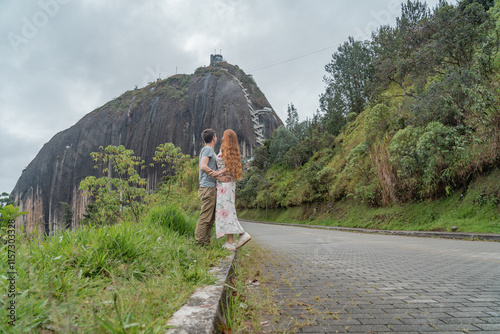 Couple in love admiring the beautiful Piedra del Peñol in Guatapa. photo