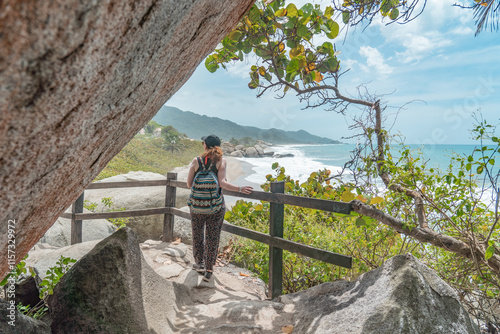 Woman walking in the magical Tayrona National Park in Colombia. Views over sea, rocks and sandy beaches.