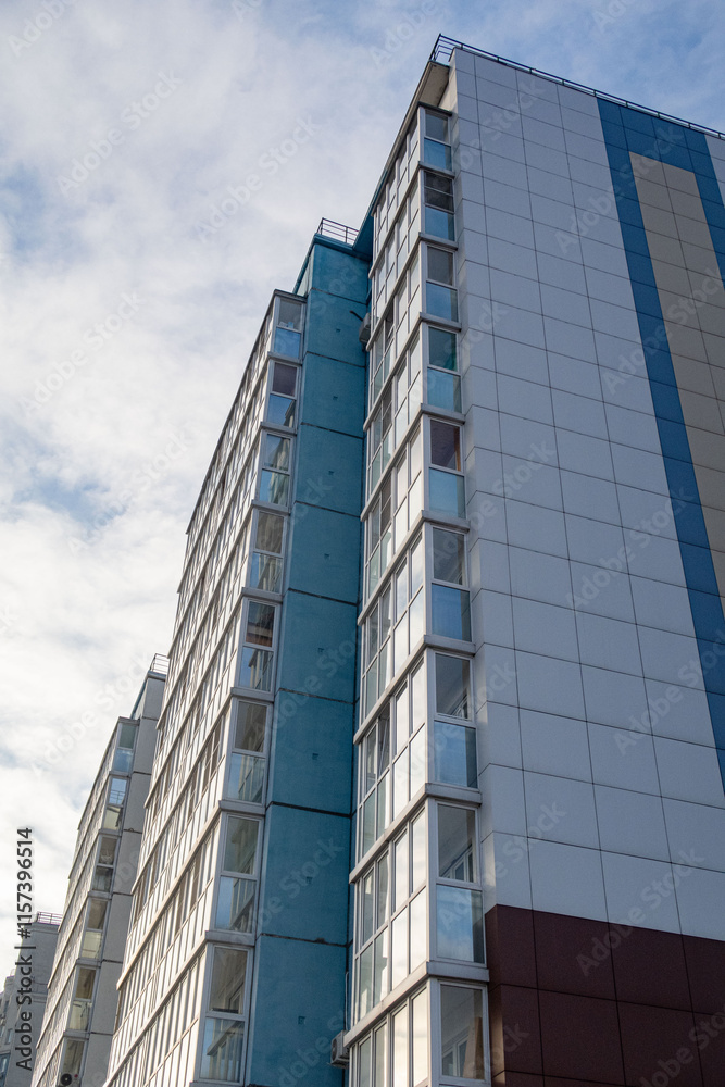 A tall building with a blue and white facade A tall building with a blue and white facade