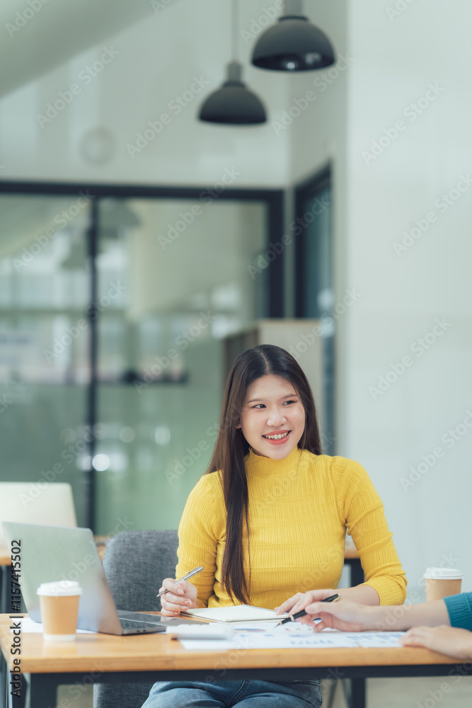 Collaborative Brainstorming: A young professional woman smiles confidently as she discusses ideas with a colleague during a productive office meeting. Collaborative Brainstorming: A young professional woman smiles confidently as she discusses ideas with a colleague during a productive office meeting.