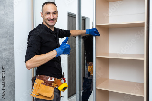 The man is engaged in repair and furniture assemblage