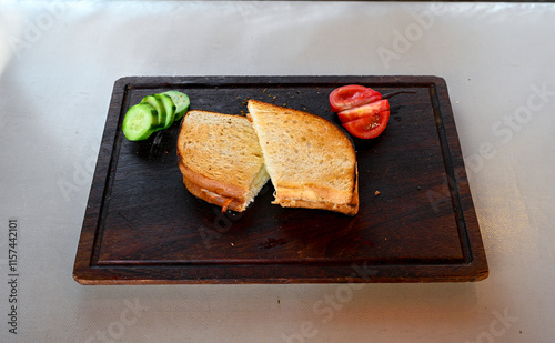 Turkish karisik atom kare  tost ( kasarli bazlama tost) . Sucuklu, Kasarli,  cheddarli, kavurmali karisik tost. Flat baked bread toasted. Karisik bazlama tost . photo