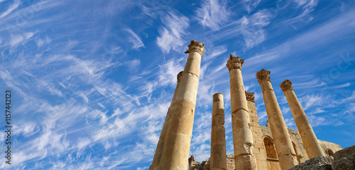 Roman Columns in the Jordanian city of Jerash (Gerasa of Antiquity), capital and largest city of Jerash Governorate, Jordan. Against the background of a beautiful sky with clouds #1157442123