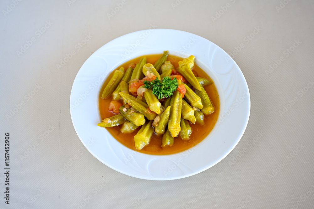 Bamya, Turkish traditional food. (Turkish cuisine) Homemade Food Okra in Plate. Organic Food. Etli bamya yemegi. Bamya, Turkish traditional food. (Turkish cuisine) Homemade Food Okra in Plate. Organic Food. Etli bamya yemegi.