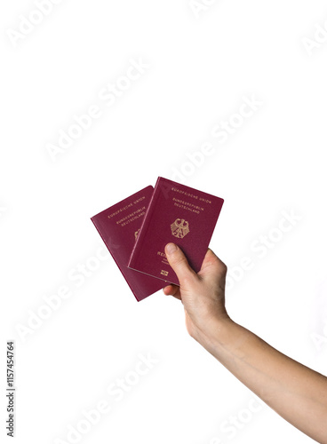 A close-up shot of a hand holding three German passports, against a clean white background with ample copy space, symbolizing travel and family mobility.