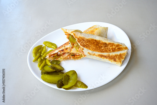 Lavash doner kebab ( soslu kasarli zurna doner durum )  or shawarma sliced in plate isolated.  Tavuk Et Doner Durum. Hatay Iskenderun usulu bazuka tavuk doner durum. photo