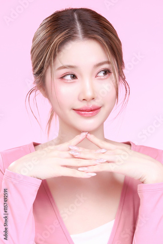 Portrait of a Smiling Asian Woman fresh skin in Stylish Pink Attire Against a Soft Background.